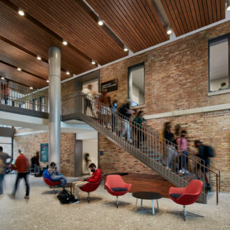 Shared glass entry at SCB's Brown Hall. Architecture. Campus Environments. Learning Environments.